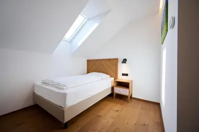 a small bedroom with a bed and a skylight at Hiša Ančka, Šenčur - 3 min to the Airport in Kranj
