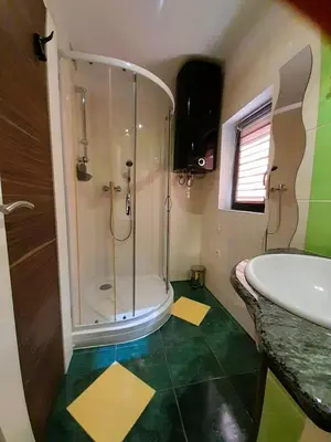 a bathroom with a shower and a sink at Apartments Radulje Bovec in Bovec
