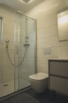 a bathroom with a toilet and a glass shower at Apartments Radulje Bovec in Bovec