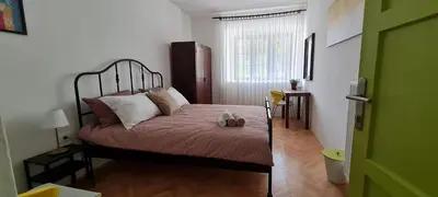 a bedroom with a bed with a teddy bear on it at Nona BB in Postojna
