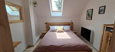 a small bedroom with a bed and a television at Nona BB in Postojna