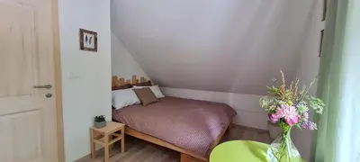 a small bedroom with a small bed in a room at Nona BB in Postojna