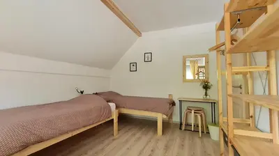 a bedroom with a bunk bed and a ladder at Nona BB in Postojna
