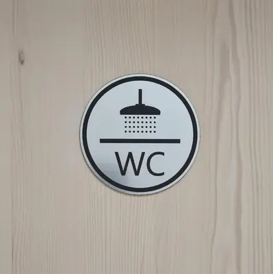 a sign on a wooden door with aww on it at Nona BB in Postojna
