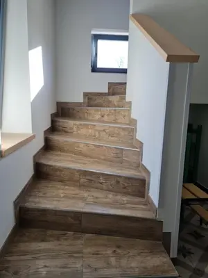 a staircase in a house with wooden floors at Nona BB in Postojna
