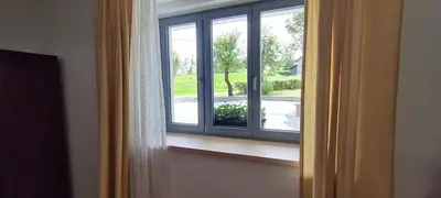 an open window with a view of a yard at Nona BB in Postojna