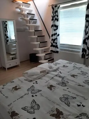 a bedroom with a bed and a staircase at APARTMA VESTER - Large 3-Bedroom Near Bled in Bled
