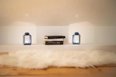 a white fur rug sitting on a shelf with two candles at APARTMA VESTER - Large 3-Bedroom Near Bled in Bled