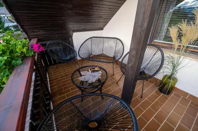 three chairs and a table on a balcony at APARTMA VESTER - Large 3-Bedroom Near Bled in Bled