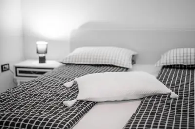 a bedroom with two beds with a pillow on it at APARTMA VESTER - Large 3-Bedroom Near Bled in Bled