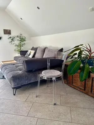 a living room with a couch and a table and a chair at Hiša Srečo in Begunje na Gorenjskem