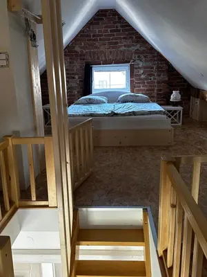 a bedroom with a bed in a brick wall at Hiša Srečo in Begunje na Gorenjskem