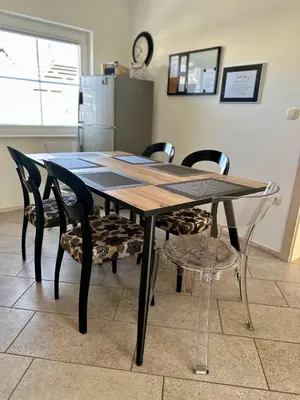 a dining room table and chairs in a kitchen at Hiša Srečo in Begunje na Gorenjskem