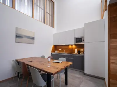 a kitchen and dining room with a wooden table and chairs at SKI Gothia in Kranjska Gora