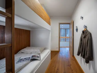 a bedroom with a bed and a hallway at SKI Gothia in Kranjska Gora