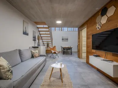 a living room with a couch and a tv at SKI Gothia in Kranjska Gora