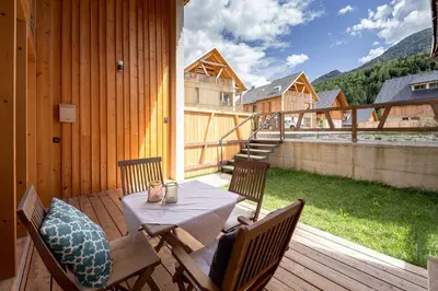 a wooden patio with a table and chairs on a deck at SKI Gothia in Kranjska Gora