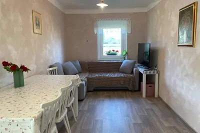 a living room with two tables and a couch at Grandma's House in Radlje ob Dravi