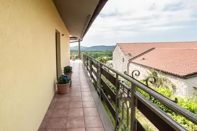 a balcony with a view of the countryside at Apartment THE VIEW HerMes arT in Sežana