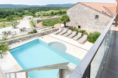 a view of the pool from the balcony of a villa at Apartment THE VIEW HerMes arT in Sežana