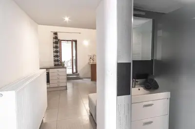 a white bathroom with a sink and a mirror at Apartment THE VIEW HerMes arT in Sežana