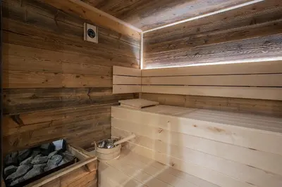 a sauna with wooden walls and a wooden ceiling at House Troha - Rooms & Apartments in Bled