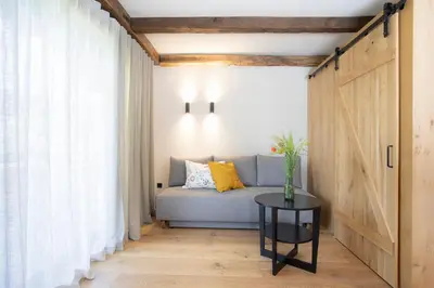 a living room with a couch and a table at House Troha - Rooms & Apartments in Bled