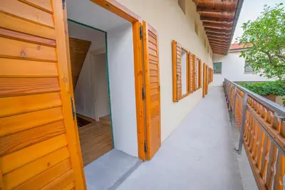 an open door of a house with a balcony at Apartma Korada in Deskle