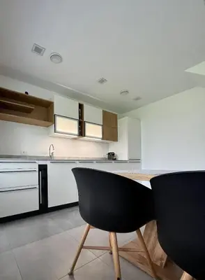 a kitchen with a table and two chairs in it at The Valley Queens in Bovec