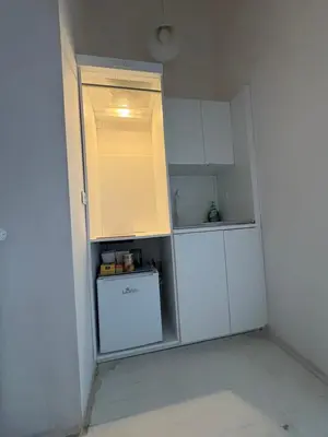 a small kitchen with a refrigerator and a washer and dryer at INDUSTRIAL STUDIO 2 in Ljubljana