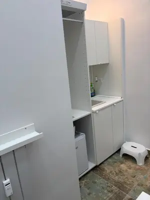 an empty kitchen with white cabinets and a toilet at INDUSTRIAL STUDIO 2 in Ljubljana