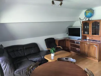 a living room with a couch and a table at Apartma Dobra misel in Bovec