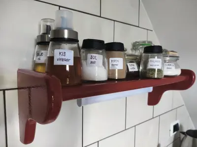 a shelf with jars on it in a kitchen at Apartma Dobra misel in Bovec