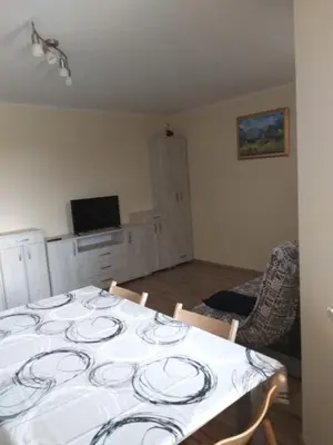 a dining room with a table with plates on it at Apartmaji Maki in Bled