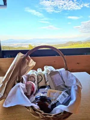 a basket of food and other items on a table at Lunela estate with sauna in Cerklje na Gorenjskem