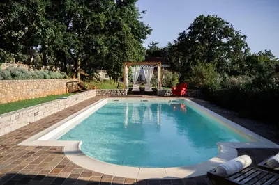 a swimming pool in a backyard with a gazebo at 9b-The Tiny House in Sežana