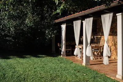 a group of white curtains on a patio at 9b-The Tiny House in Sežana