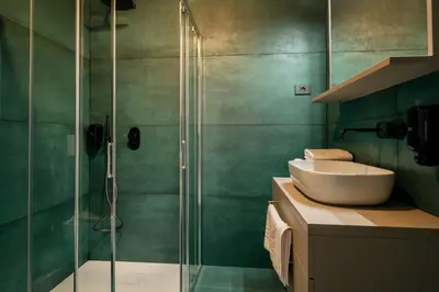a bathroom with a sink and a glass shower at Dvorec Gregorčič in Smarjeske Toplice
