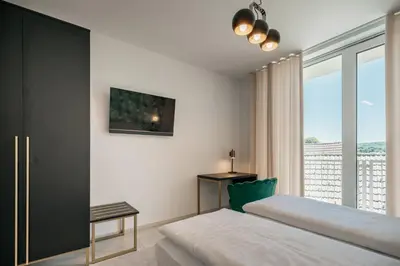 a bedroom with a bed and a large window at Dvorec Gregorčič in Smarjeske Toplice
