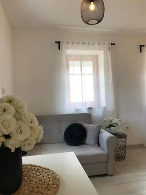 a living room with a couch and a window at Apartma 64 in Bovec