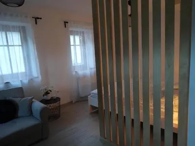 a living room with a sliding door to a room with a couch at Apartma 64 in Bovec