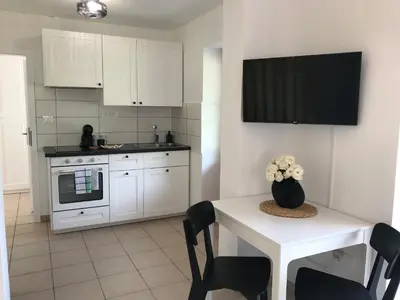 a kitchen with a table with a vase of flowers on it at Apartma 64 in Bovec