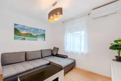 a living room with a couch and a window at Penzion Hosnar, apartma Lev in Bovec