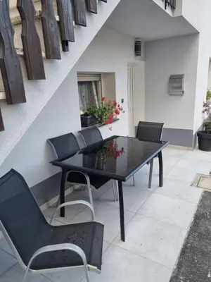 a black dining table and chairs on a patio at Penzion Hosnar, apartma Lev in Bovec