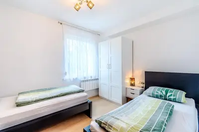 a bedroom with two beds and a window at Penzion Hosnar, apartma Lev in Bovec