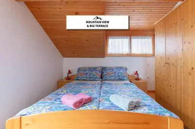 a bedroom with a bed with two pillows on it at Apartmaji Marko in Bled