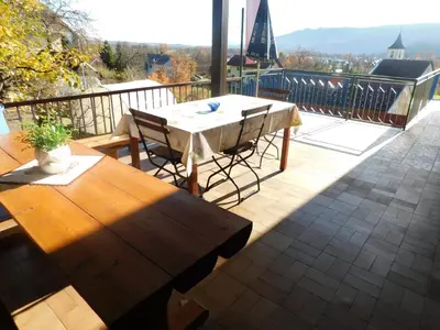 a patio with a table and chairs on a balcony at Apartmaji Marko in Bled
