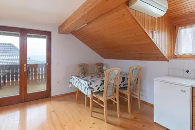 a kitchen and dining room with a table and chairs at Apartmaji Marko in Bled