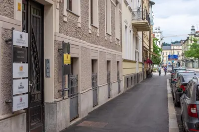 a street with cars parked on the side of a building at Loni's Place Apartments in Ljubljana