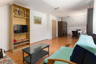 a living room with a couch and a table at Apartmaji Trstenjak in Rateče